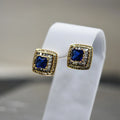 Cubic Zirconia clustered stud square earrings with blue stone center